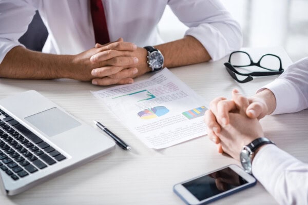 depositphotos 151250374 stock photo businessmen discussing charts