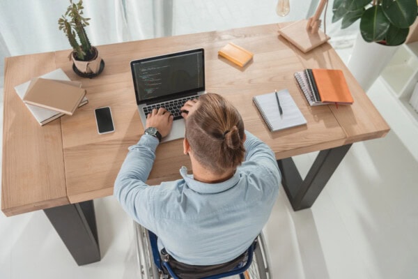 depositphotos 173494318 stock photo disabled man using laptop