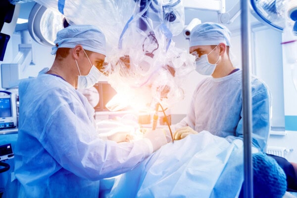 depositphotos 316171442 stock photo spinal surgery group surgeons operating