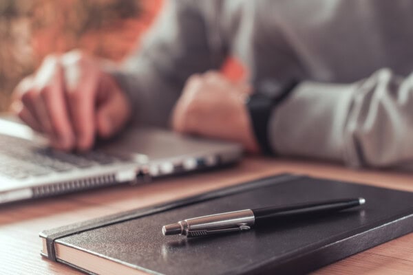 pencil and notebook and freelancer's work desk in home office