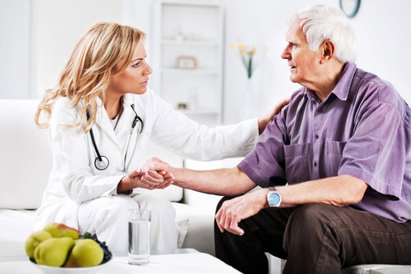 female doctor examining an elderly patient.