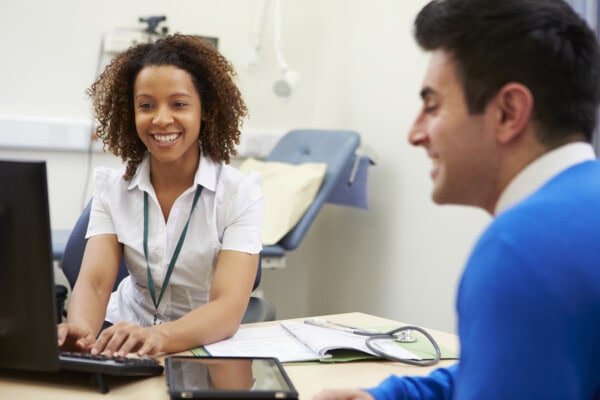 female consultant meeting with male patient